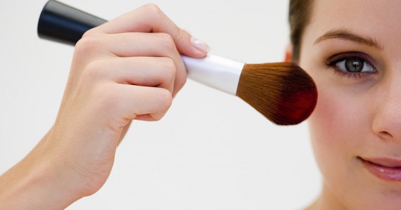 Woman applying blush