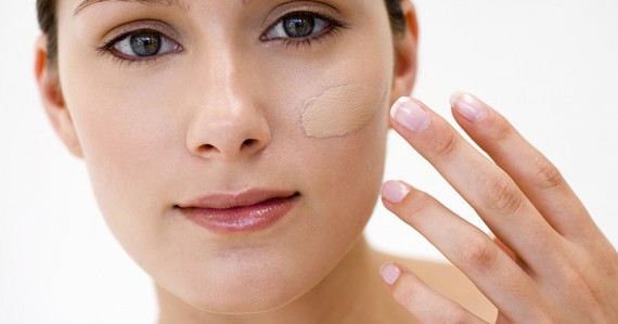 Woman applying concealer