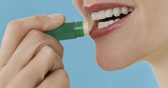 Close-Up of a Woman Applying Lip Balm