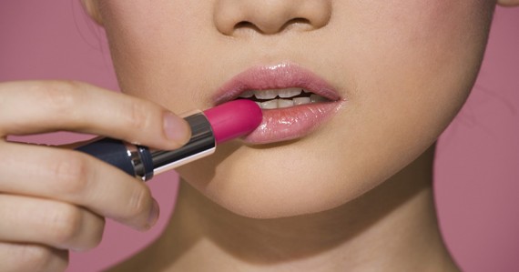 Woman applying lipstick