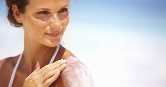 Lovely woman applying lotion